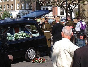 The coffin is placed in the hearse